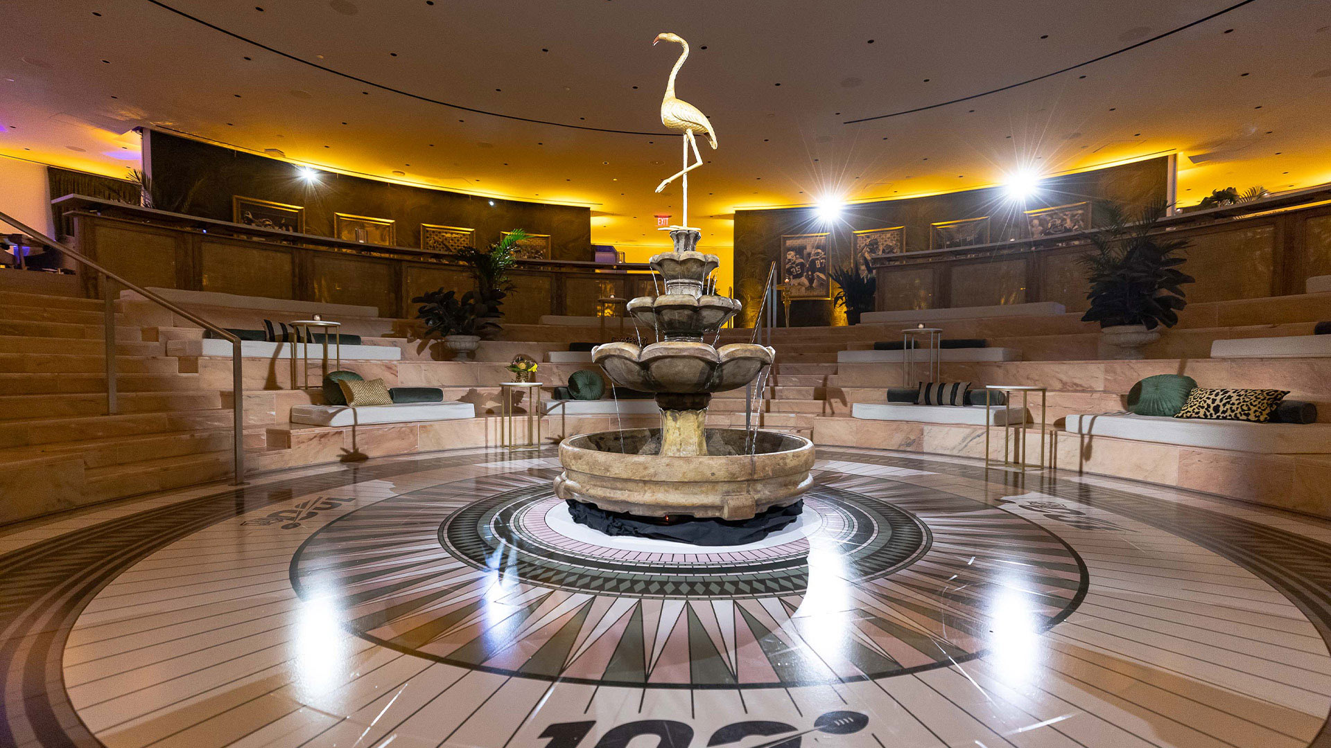 beautiful fountain with a statue of a white flamingo rising from the center 